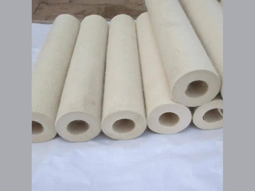 Nỉ bọc trục chịu nhiệt: Những ống nỉ trắng đứng cạnh nhau, độ dày thành ống khác nhau