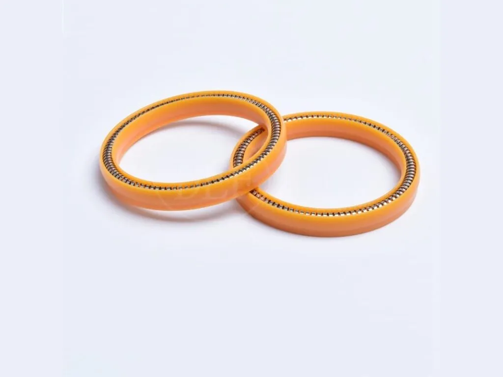 Phớt PTFE: Hai phớt lò xo màu cam xếp chồng nhìn nghiêng