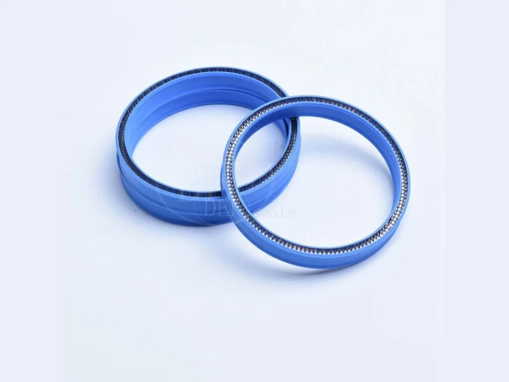 Phớt PTFE: Hai phớt PTFE xanh dương có lò xo, đặt nghiêng cạnh nhau