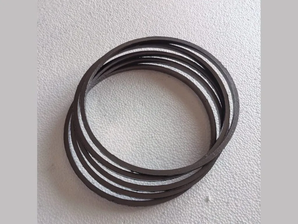 Vòng graphite nén: Nhiều vòng graphite đen mảnh xếp chồng lệch nhau trên nền xám